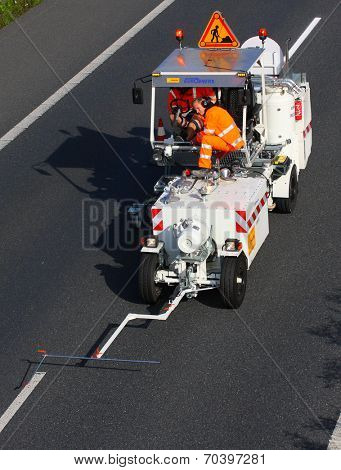 PILSEN CZECH REPUBLIC - AUGUST 19, 2014: Unidentified workers driving maintenance vehicle. Painting new road signs on highway D5 Praha - Rozvadov.