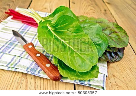 Mangold with knife on napkin and board