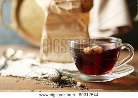 Beautiful vintage composition with herbal tea, on wooden table
