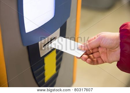 Woman Inserting Parking Ticket Into Machine