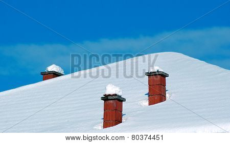 Rooftop Chimneys Under Snow