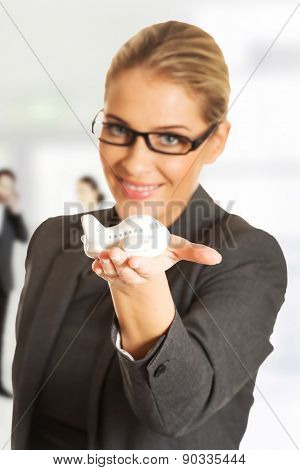 Beautiful businesswoman with plane toy in hand.