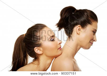 Two attractive topless sisters with make up.