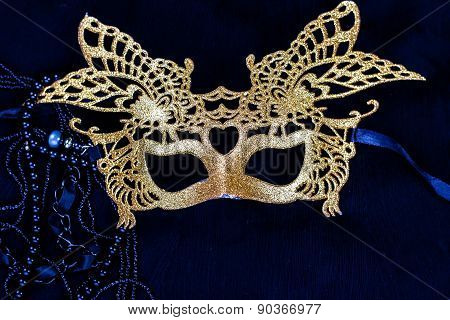 golden carnival mask on dark background