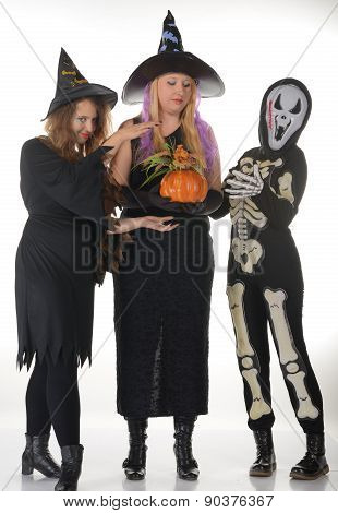 Three women witches posing in scary outfits