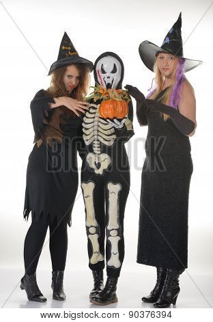 Three women witches posing in scary outfits