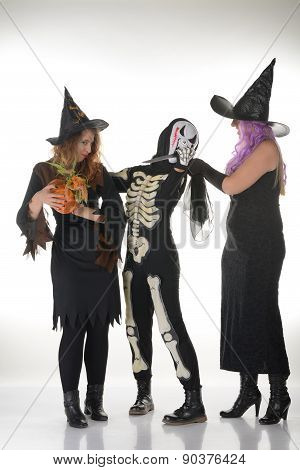 Three women witches posing in scary outfits