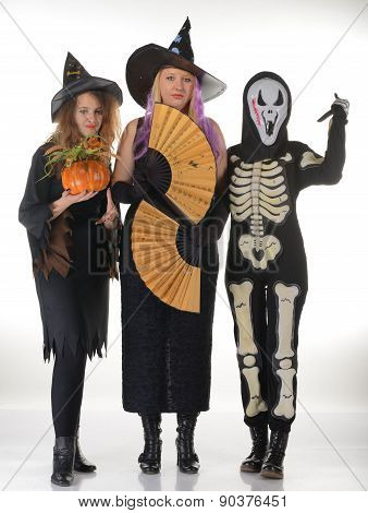 Three women witches posing in scary outfits