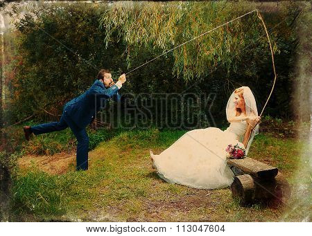 bride cought a groom for her with a fishing rod, Retro variant.