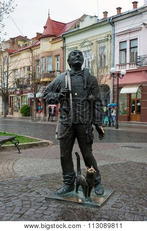 Mukachevo, Ukraine - April 6, 2015: Monument of Happy Chimney Sweeper and his cat. The monument with real chimney sweeper Bertalon Tovt by Ukrainian sculptor Ivan Brovdi