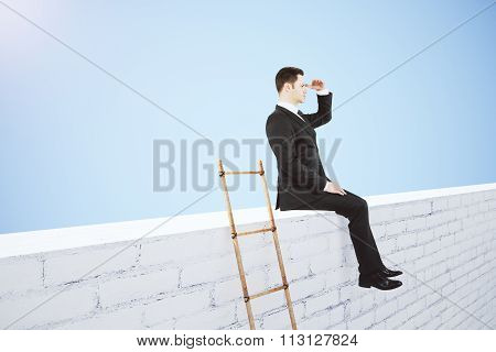 Business Leader Concept With White Brick Wal, Wooden Stairway And Businessman Looking Into The Dista