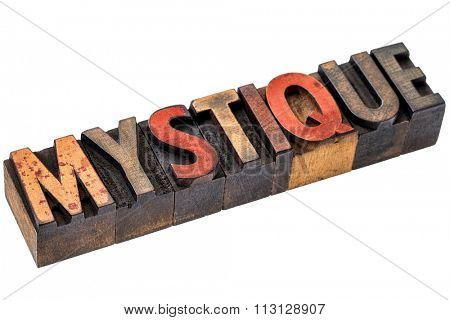 mystique word abstract  - an isolated banner in vintage letterpress wood type stained by color inks