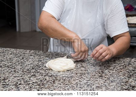 Close Up Of Female Hands Kneading Dough And Making Banitsa