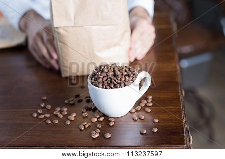 Close-up Of Cup With Coffee Beans