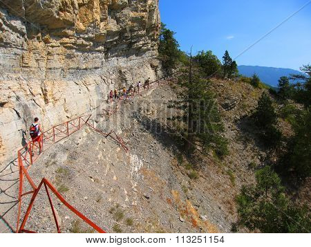 CRIMEA, UKRAINE - AUGUST 27, 2009: Tourist going by risky road in hills, called Botkin road. Recorded in hills of Crimea in Ukraine.