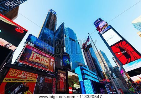 NEW YORK CITY - OCTOBER 13, 2015: Times Square with skyscrapers and neon advertisement. It is one of the worlds busiest pedestrian intersections and a major center of worlds entertainment industry