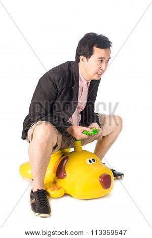 Young Asian Businessman Driving A Baby Toy Car Look Like Dog, Isolated