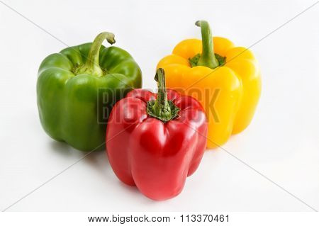 Fresh peppers. Three sweet Red Yellow Green Peppers isolated on white background.