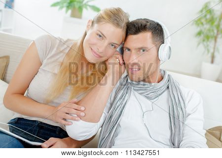 Couple listening on headphones
