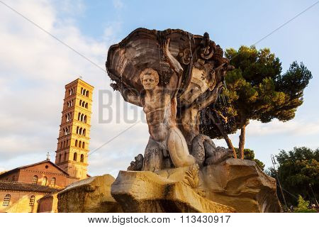 historical fountain with the church Santa Maria in Cosmedin in Rome