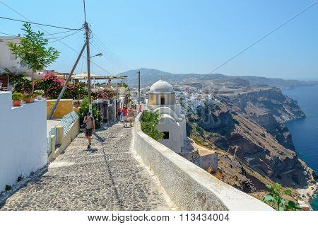 Old traditional narrow stone made street promenade to Thira town on cliff of Santorini island.