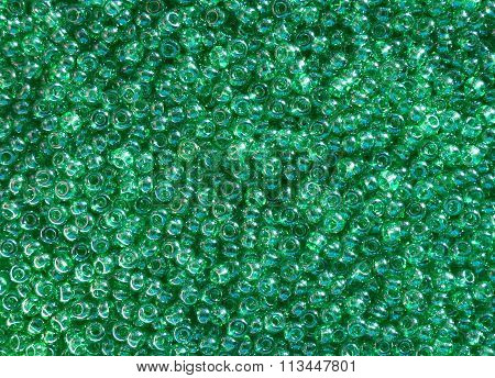 Shiny green seed beads background