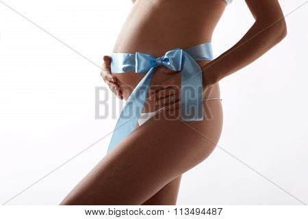 Pregnant woman belly, with blue stripe, white background.