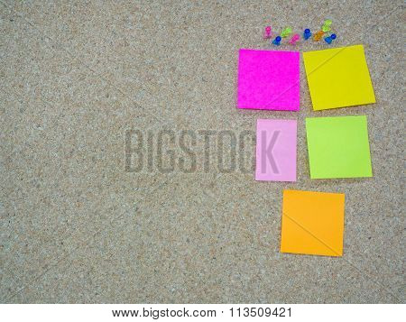 Group Of Thumbtacks Pinned And Paper Note On Cork Board
