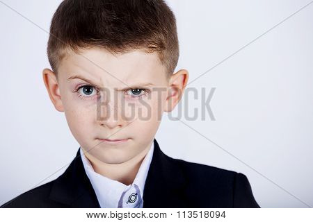 Funny emotion of little boy young man with a raised eyebrow wearing costume with braces.