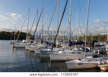 Luxury Sail Yachts Moored Along A Pier  In Bowness-on-windermere On Lake Windermere In Cumbria