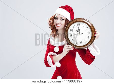 Time And Christmas Holiday Concept. Smiling And Gleeful Red-haired Santa Helper Showing Time On Big