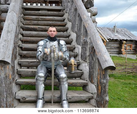 Knightly armor and weapon. Semi - antique photo.