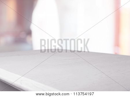 White wooden table on blurred interior background