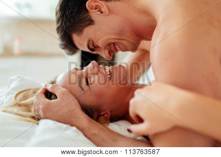 Happy Couple In Bedroom
