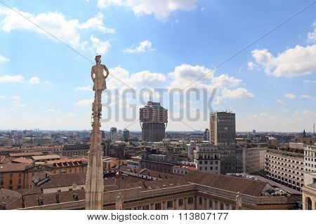 Cathedral statue and view of Milan cityscape with Torre Valesca
