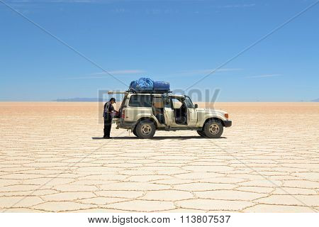 Salar Uyuni Bolivia - 26 November 2012: A Tourist Jeep is driving through Salar Uyuni. A Jeep Tour through the Bolivian Salt Desert Uyuni is a popular touristic activity on the Altiplano in Bolivia