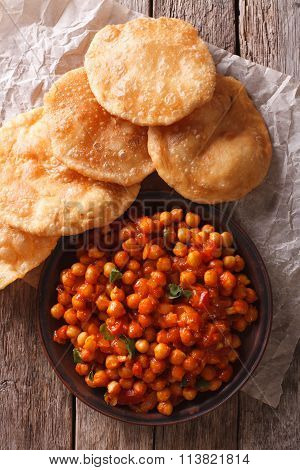 Delicious Indian Chana Masala And Puri Close-up. Vertical Top View