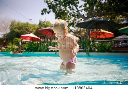 Closeup Small Blonde Girl Smiles Plays In Shallow Swimming Pool