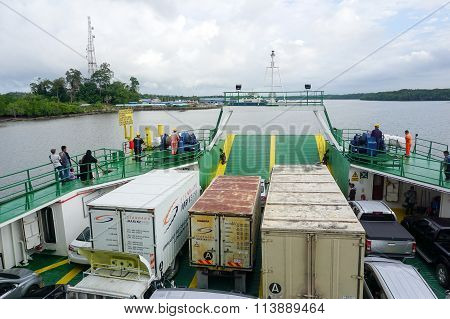 MENUMBOK, SABAH - JAN 6, 2016: Ferry with vehicles on board in the morning,carries passengers.
