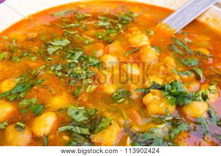 Indian potato gravy dish garnished with coriander