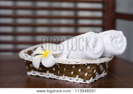 Spa Composition Of Towels And Flowers In A Basket