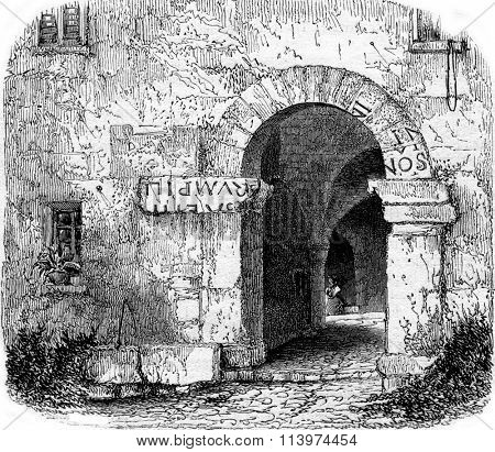 Fragments of the registration of Augustus on the door of a house in La Turbie, vintage engraved illustration. Magasin Pittoresque 1853.