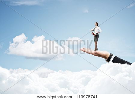 Palm supporting businesswoman