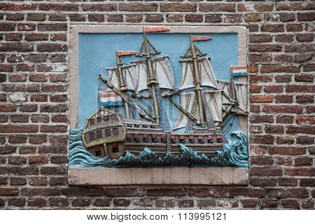 AMSTERDAM, The Netherlands - JULY 9 2014: Decorative gable stone in the wall of an ancient building in Amsterdam. In Middle Ages, these were used to identify the houses as many people couldn't read.