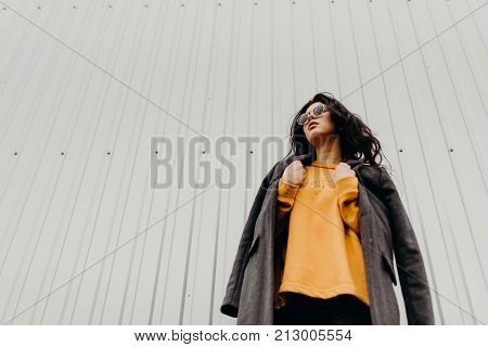 Portrait Of Stylish Modern Young Curly Woman In Coat Sunglasses