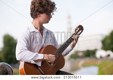 Guitar romantic man city musician concept. Playing stringed instruments lessons. Lifestyle of talented people.