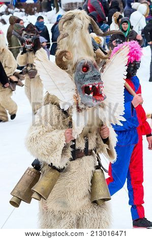 Razlog, Bulgaria - January 14, 2017: People in traditional carnival kuker costumes at Kukeri festival Starchevata