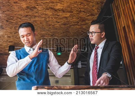 Two angry business partners quarreling in offce on meeting.