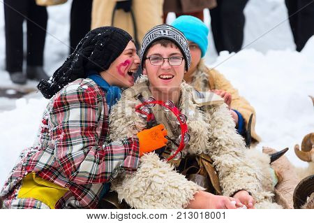 Razlog, Bulgaria - January 14, 2017: Teenagers in traditional carnival kuker costumes having fun at Kukeri festival Starchevata
