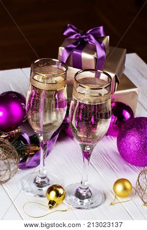 Champagne and Gifts.New Year Celebration. Christmas decorations with wineglass. toasting with champagne glasses